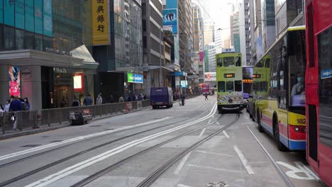 Static-view-of-double-decker-trams-in-traffic-on-street-in-Hong-Kong