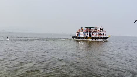 Traditional-tourist-water-boats-riding-tourists-from-Alibaug-to-Gateway-Of-India,-Mumbai