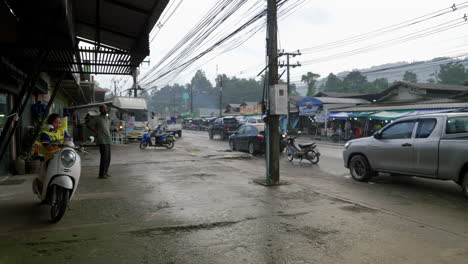 Koh-samui-rainy-day-as-locals-wait-for-weather-to-pass,-busy-street