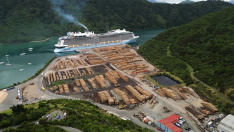 Aerial-circular-view-of-the-harbor-of-Picton-with-cruise-ship-docked-and-a-cargo-of-lumber-on-the-quay