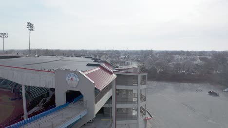 McCoy-Stadium-in-Pawtucket-Rhode-Island,-drone-showing-back-side-of-abandoned-baseball-field-and-parking-lot,-aerial
