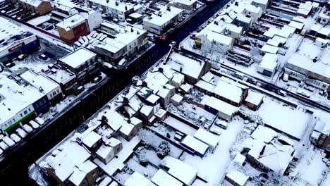 London-ice-cold-aerial,-flying-above-the-roads-and-white-winter-landscape