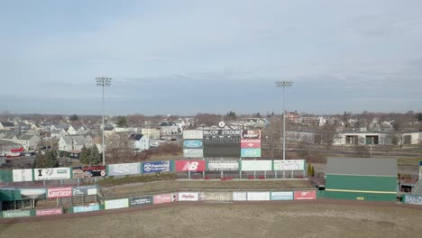McCoy-Stadium-in-Pawtucket-Rhode-Island,-drone-shot-starting-on-scoreboard-the-revealing-the-abandoned-stadium,-aerial