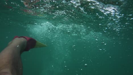Dramatic-fins-kicking-water-revealing-depths-below-of-waikiki-beach-oahu