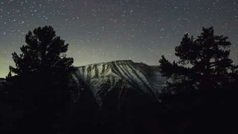 Astro-night-timelapse-Mountain-Olympus-Snowy-Peaks-Pine-forest-trees-tilt-up