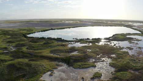 Blue-hole-utah-at-sunrise-with-glistening-light-over-wetlands-marsh