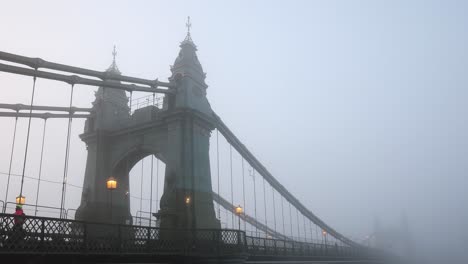 Commuters-walking-across-Hammersmith-Bridge-on-a-foggy-winter-morning