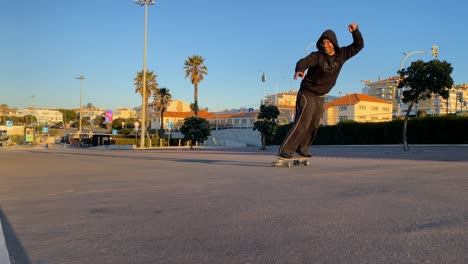 Excited-man-carving-skate-park-in-estoril-street-on-summer-day