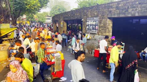 A-static-shot-of-people-having-street-food-by-the-entrance-of-the-Gate-way-of-India