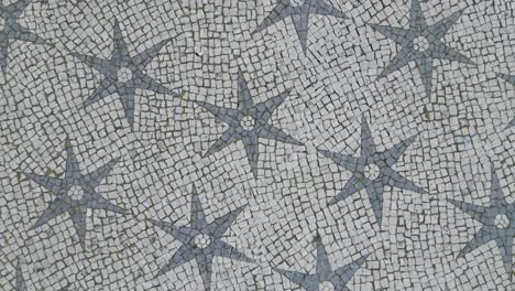 aerial-top-view-of-the-mosaic-floor-showing-the-historical-stars-in-Chapel-square,-Lisbon,-Portugal