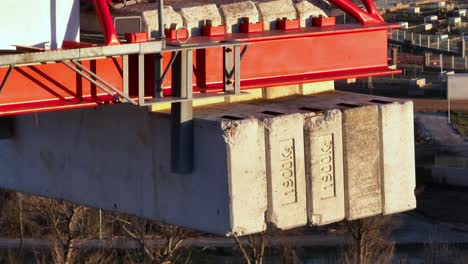 Very-heavy-stone-blocks-being-used-as-counterweight-in-a-crane,-aerial-view
