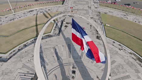 Slow-motion-of-flag-waving-over-triumphal-arch-in-plaza-de-la-Bandera,-Santo-Domingo-in-Dominican-Republic