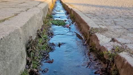 Beautiful-street-drainage-water-canal-in-Sopot,-Bulgaria