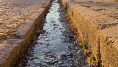 Beautiful-golden-hour-street-drainage-canal-in-Sopot,-Bulgaria