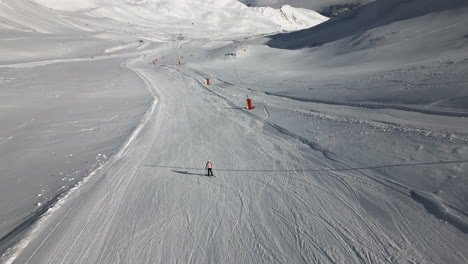 Aerial-Follow-of-Female-Skiing-down-Ski-Hill-in-Serfaus-Austria