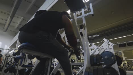 Black-Male-Bodybuilder-Strongman-Athlete-Preparing-to-Train-Back-Muscle-On-Sports-Equipment-in-4K