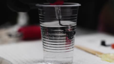 Needle-dissolving-ink-in-water-when-tattooing