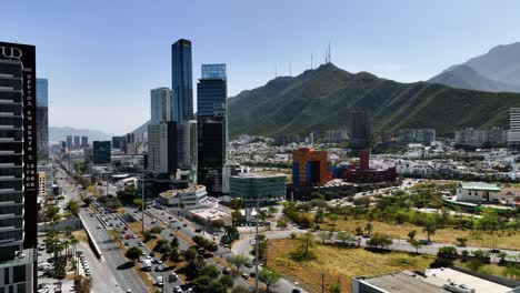 Aerial-view-around-traffic-and-skyscrapers-in-sunny-San-Pedro-Garza-Garcia,-Monterrey,-Mexico