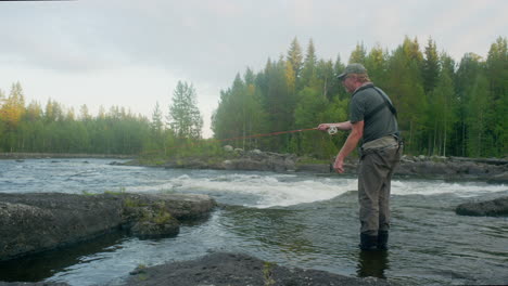 Fly-fisherman-fishing-in-a-river-casting-with-a-fly-rod