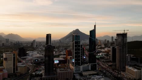 Aerial-view-rising-over-high-rise-in-San-Pedro-Garza-Garcia,-evening-in-Monterrey,-Mexico