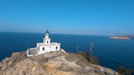 First-person-view-of-drone-flying-over-light-house-on-Greek-island