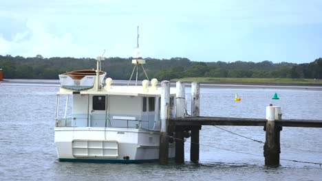 Old-Boat-tied-to-Jeti-at-Seaside-Country-Town-in-Gold-Coast,-Queensland