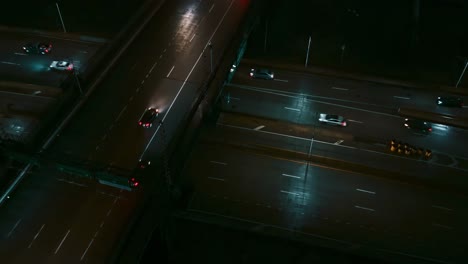 Overpass-highway-at-night,-drone-shot-looking-down-at-angle,-night
