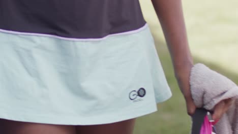 Close-up-shot-of-a-padel-outfit-of-a-girl-with-towel-in-hand