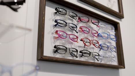 Eye-glasses-on-wall-in-an-optometry,-eye-doctor-clinic