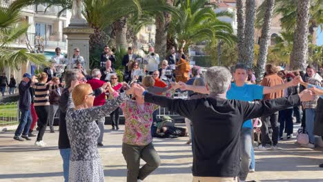 Sardana-dance-in-Catalonia-typical-cultural-historical-folk-dance-in-the-square-of-Sitges-with-live-music