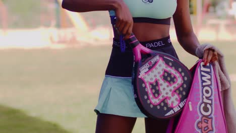 Close-up-of-a-beautiful-black-woman-taking-her-new-paddle-racket-out-of-its-case
