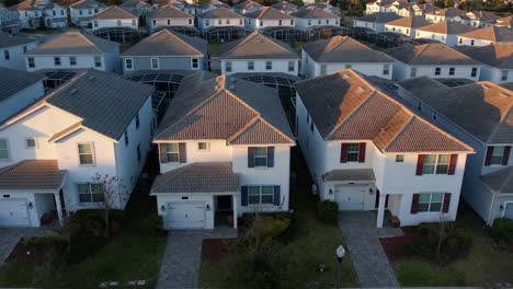 Aerial-view-of-a-neighborhood-with-similar-houses,-sunny-evening-in-Florida,-USA