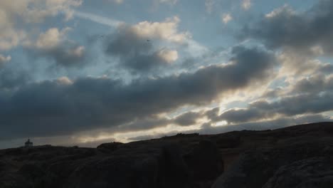 Timelapse-of-moving-clouds-above-Portugal-rocky-coast,-Praia-de-Norte-or-North-Beach