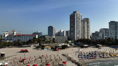 Aerial-view-towards-people-on-the-Playa-De-Bocagrande-beach,-in-sunny-Cartagena,-Colombia