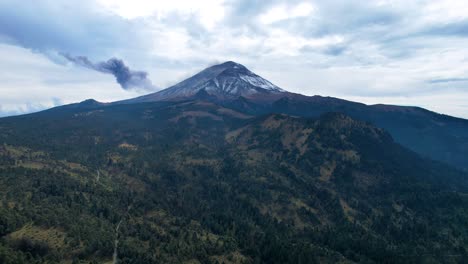 Absteigende-Drohnenaufnahme-Eines-Aktiven-Vulkans-In-Mexiko-Und-Des-Umliegenden-Waldes