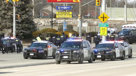 Police-walk-in-a-line-on-protesters-blocked-road,-supporters-of-Freedom-convoy-in-Windsor,-Canada