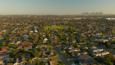 Aerial-ramp-shot-showing-suburban-sporting-field-and-revealing-the-endless-city-of-greater-Melbourne