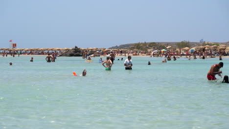 People-swimming-in-the-clear-waters-of-Elafonissi-Beach,-Crete