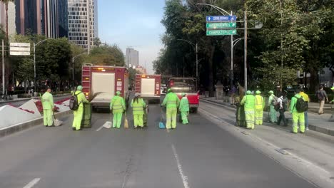 shot-of-cleaning-services-from-Mexico-City-sweeping-the-avenue-after-the-passage-of-firefighters