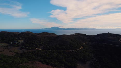 Tarifa-woodland-aerial-view-flying-towards-coastline-mountain-landscape-on-the-misty-Mediterranean-skyline