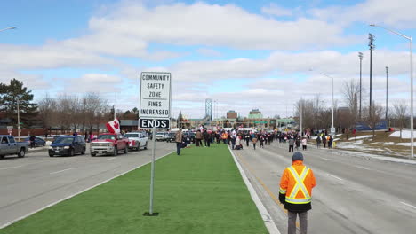 Walking-Towards-Crowd-Of-Protesters-On-The-Street-In-Windsor,-Canada-During-Truckers-Convoy-Demonstration-Against-Mandatory-Vaccination