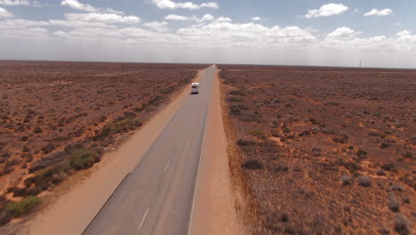Camper-Van-on-Long-Australian-Outback-Highway-on-a-Sunny-Hot-Day