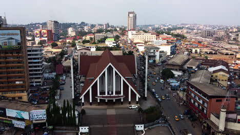 Drone-shot-tilting-towards-Cathedral-of-Our-Lady-of-Victories-in-Yaounde,-Cameroon