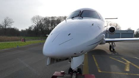 Embraer-ERJ135-jet-being-towed-by-tractor-tug-truck,-POV-point-of-view