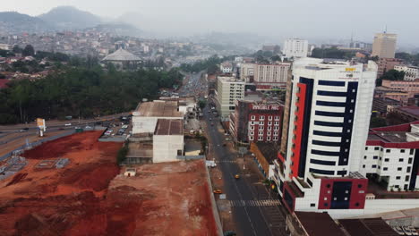 Aerial-view-following-traffic-on-the-Avenida-Merechal-Foch,-in-Yaounde,-Cameroon