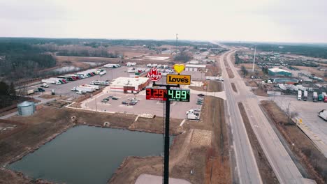 Static-aerial-of-Loves-truck-stop-sign-with-Arbys-fast-food-restaurant