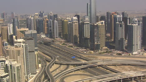 Aerial-establishing-shot-of-downtown-Dubai-with-Sheikh-Zayed-road-running-in-between