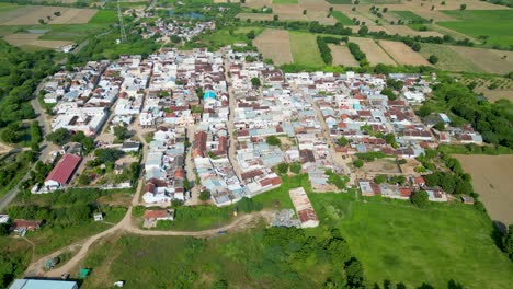 Wide-shot-of-small-Indian-Village,-Country-side-covered-with-green-farms,-small-walkways,-Gujrat-village,-rural-development