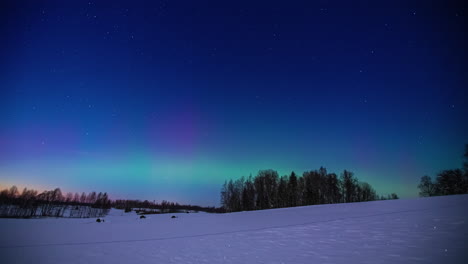 Shimmering-glow-of-the-aurora-borealis-over-a-northern-winter-wilderness---time-lapse