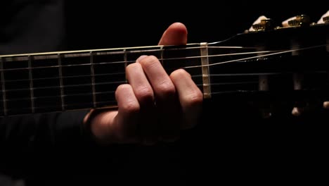 Shot-of-guitarist-hand-moving-up-and-down-the-neck-of-a-guitar